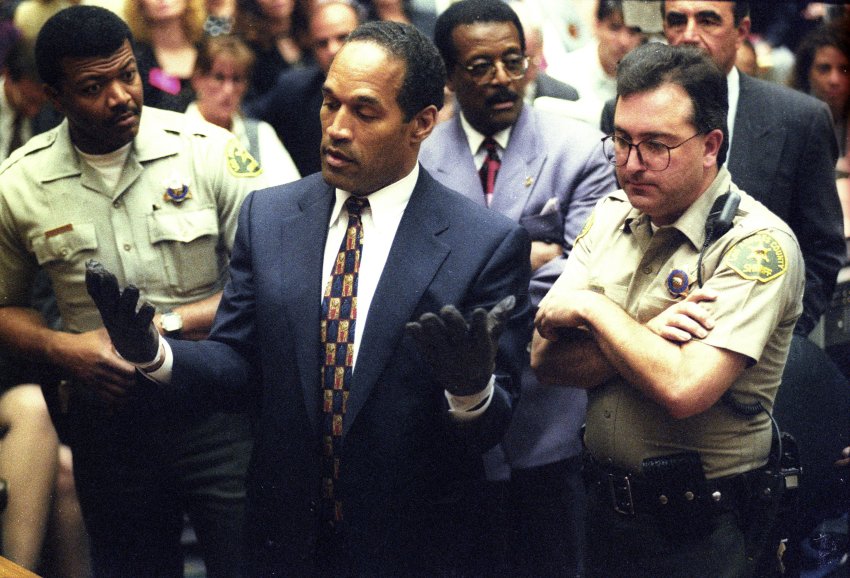 O.J. Simpson holds his hands up to the jury during testimony in Los Angeles